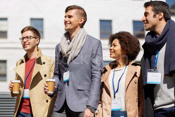 office workers with coffee on city street Stock photo © dolgachov