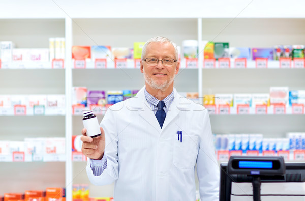 senior apothecary with drug at pharmacy Stock photo © dolgachov
