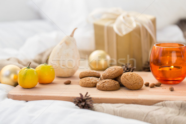 cookies, lemon, candle and christmas gift at home Stock photo © dolgachov
