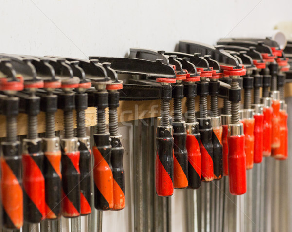 one-handed bar clamps hanging on wall Stock photo © dolgachov