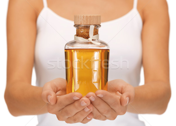 Femminile mani olio bottiglia luminoso foto Foto d'archivio © dolgachov
