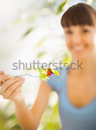 Stock photo: woman hand holding fork with vegetables
