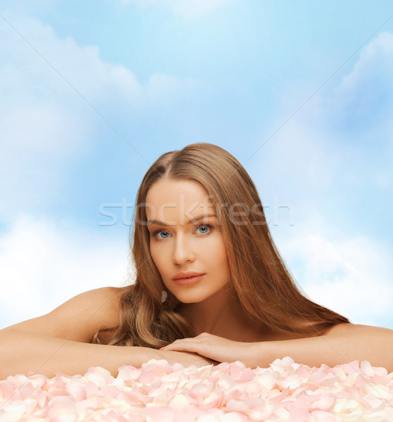 beautiful woman with long hair and rose petals Stock photo © dolgachov