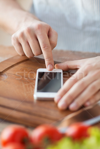 closeup of man pointing finger to smartphone Stock photo © dolgachov