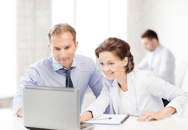 man and woman working with laptop in office Stock photo © dolgachov