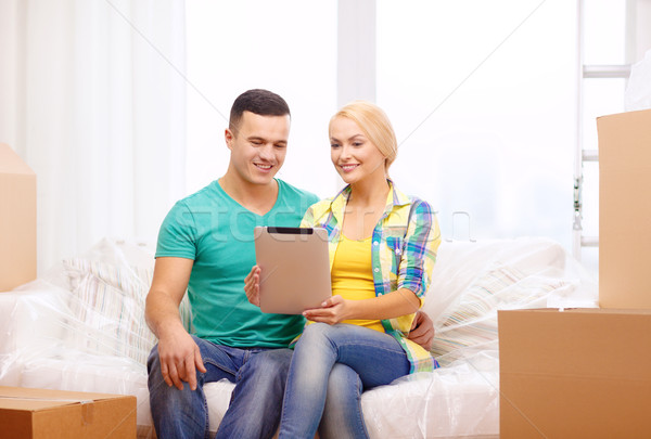 couple relaxing on sofa with tablet pc in new home Stock photo © dolgachov