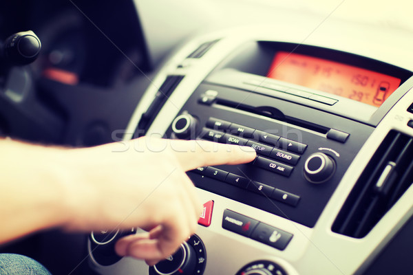 Stock photo: man using car audio stereo system