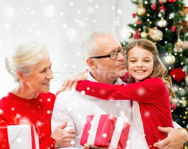 smiling family with gifts at home Stock photo © dolgachov