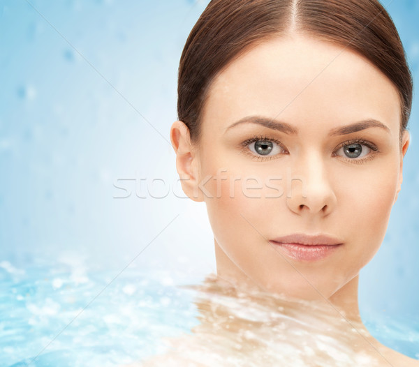 face of beautiful young woman and water splash Stock photo © dolgachov