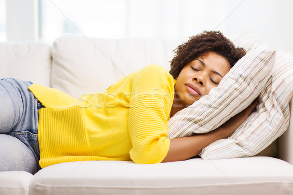 african young woman sleeping on sofa at home Stock photo © dolgachov