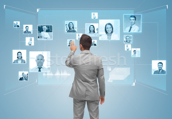 businessman with contacts icons on virtual screen Stock photo © dolgachov