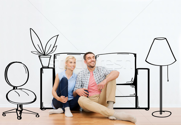 happy couple of man and woman moving to new home Stock photo © dolgachov