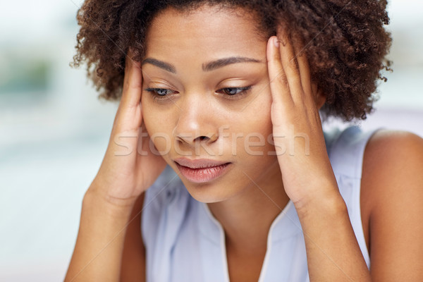 Stock photo: close up of african young woman touching her head