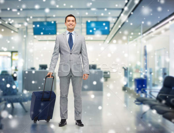 happy businessman in suit with travel bag Stock photo © dolgachov