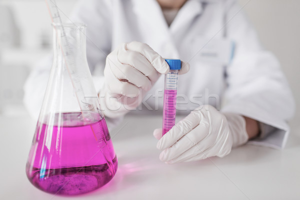 close up of scientist with tube in laboratory Stock photo © dolgachov