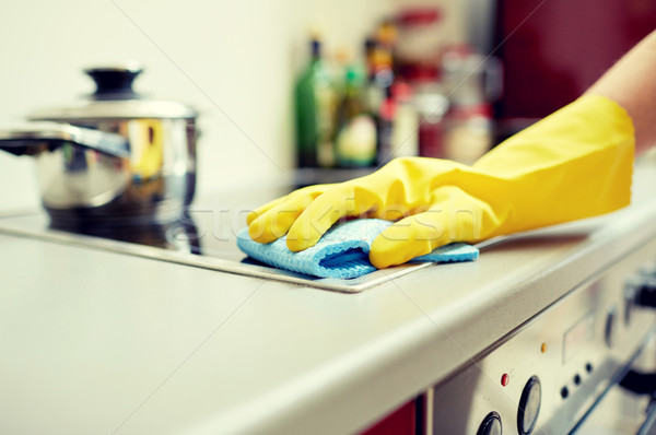 close up of woman cleaning cooker at home kitchen Stock photo © dolgachov