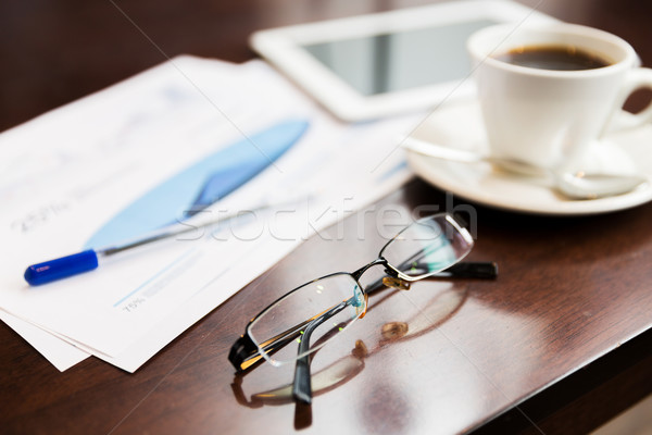 close up of glasses, tablet pc, charts and coffee Stock photo © dolgachov