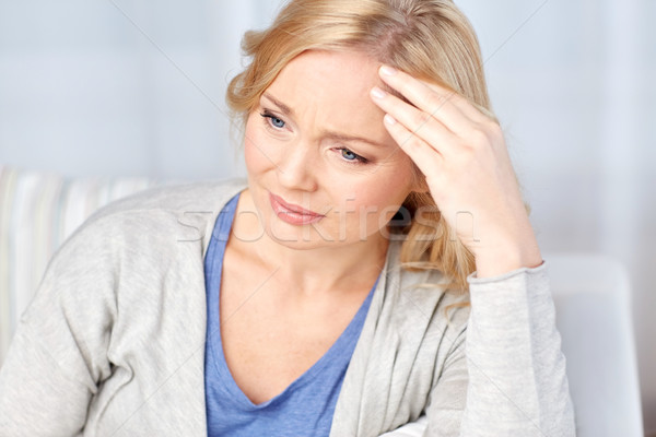 woman suffering from headache at home Stock photo © dolgachov