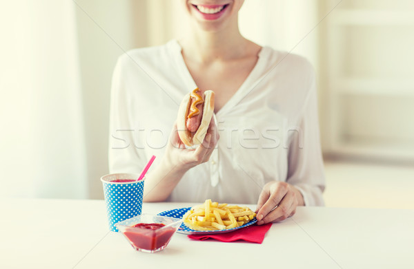 close up of woman eating hotdog and french fries Stock photo © dolgachov