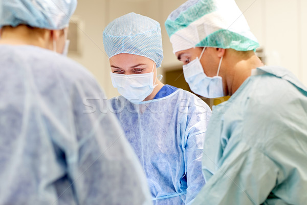 group of surgeons in operating room at hospital Stock photo © dolgachov