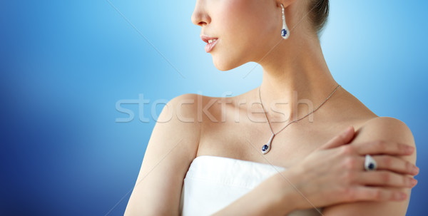 beautiful woman with earring, ring and pendant Stock photo © dolgachov