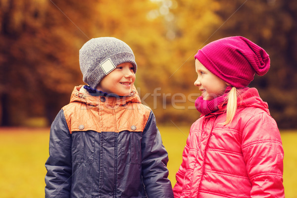 happy little girl and boy talking in autumn park Stock photo © dolgachov