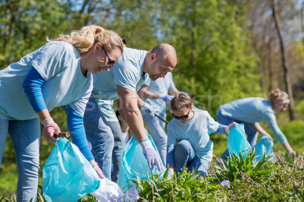 volunteers with garbage bags cleaning park area Stock photo © dolgachov