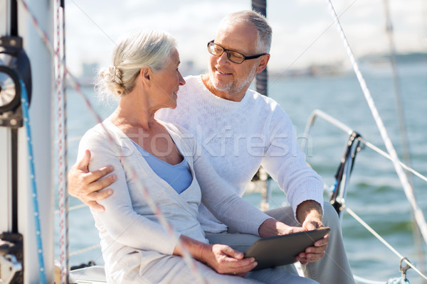 senior couple with tablet pc on sail boat or yacht Stock photo © dolgachov
