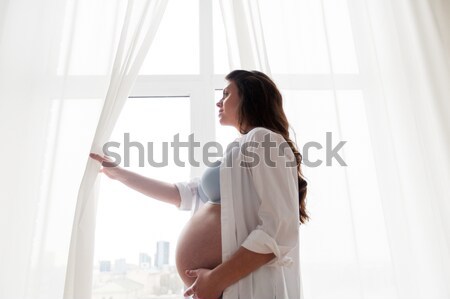 happy pregnant woman with big bare tummy at home Stock photo © dolgachov
