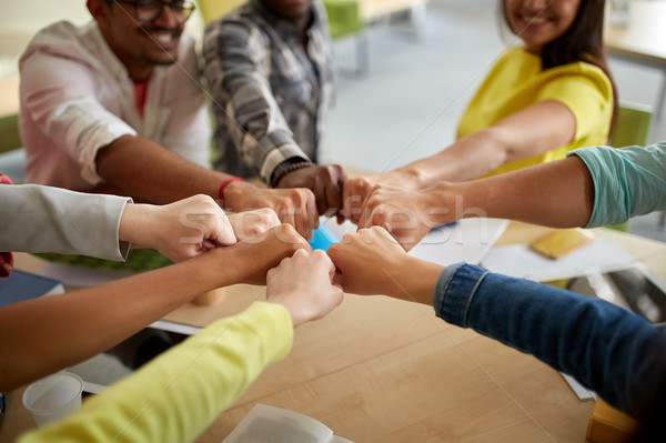 close up of international students hands fist bump Stock photo © dolgachov