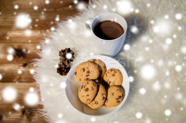 cups of hot chocolate with cookies on fur rug Stock photo © dolgachov