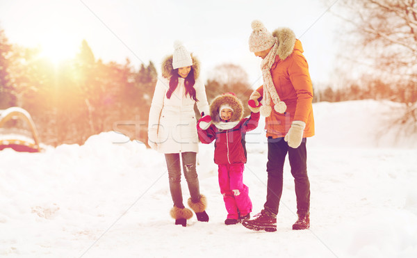 happy family in winter clothes walking outdoors Stock photo © dolgachov