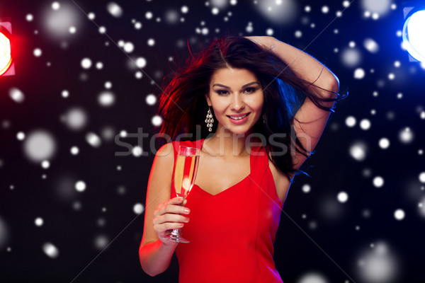 beautiful woman with champagne glass at nightclub Stock photo © dolgachov