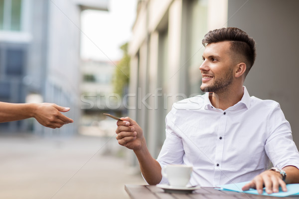 man with credit card paying for coffee at cafe Stock photo © dolgachov