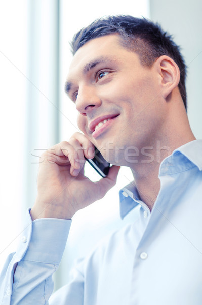 Uśmiechnięty biznesmen smartphone biuro działalności technologii Zdjęcia stock © dolgachov