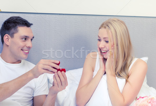 man giving woman little red box and ring in it Stock photo © dolgachov