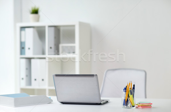 laptop with pen and stickers on office table Stock photo © dolgachov