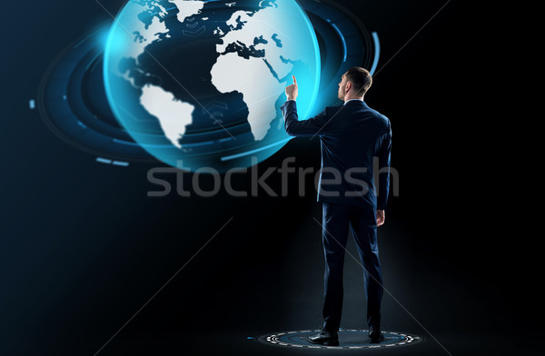 üzletember öltöny megérint Föld földgömb hologram Stock fotó © dolgachov
