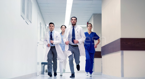 group of medics walking along hospital Stock photo © dolgachov