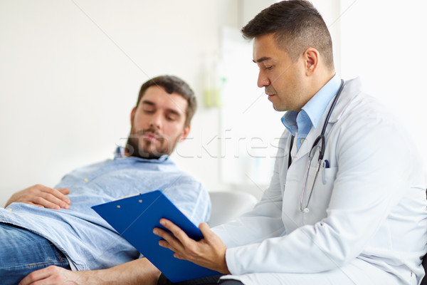 Stock photo: doctor and man with health problem at hospital