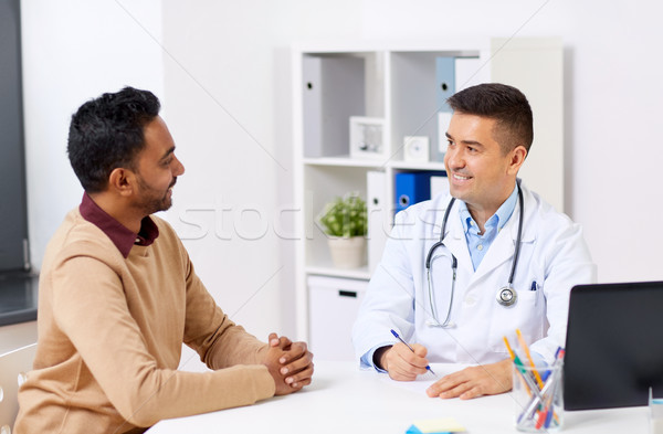 happy doctor and male patient meeting at clinic Stock photo © dolgachov