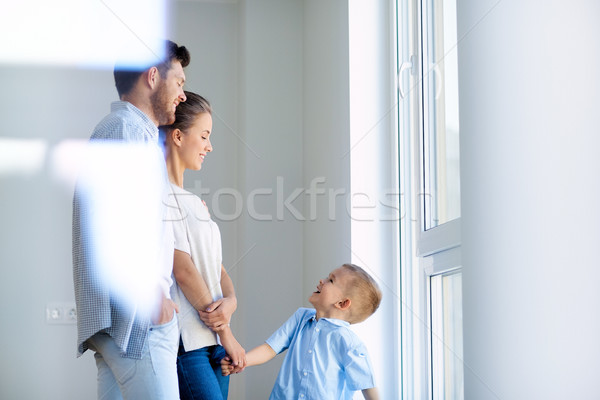 happy family with child at new home or apartment Stock photo © dolgachov