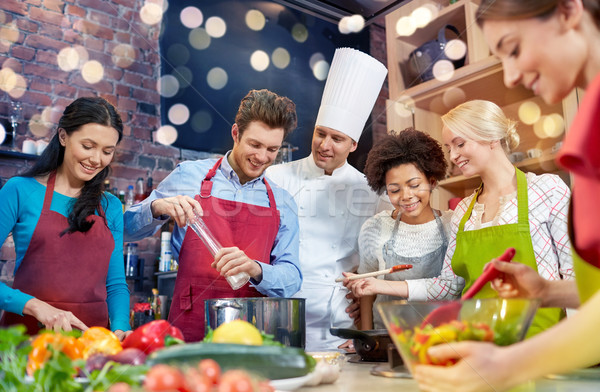 happy friends and chef cook cooking in kitchen Stock photo © dolgachov