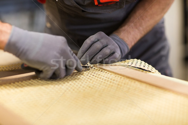 Stock photo: assembler with cutter making furniture