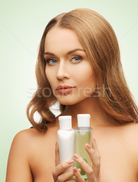 woman with cosmetic bottles Stock photo © dolgachov