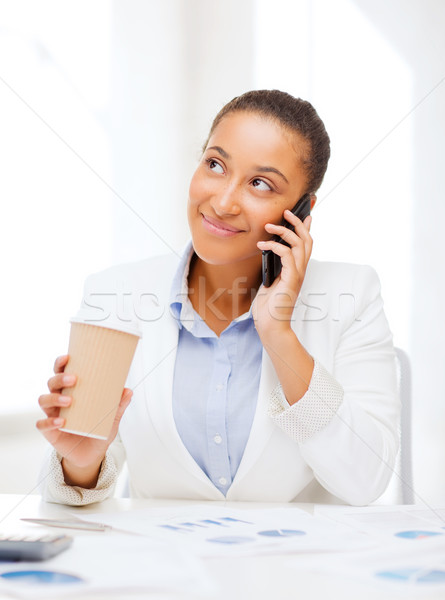 Stock photo: african businesswoman with smartphone in office