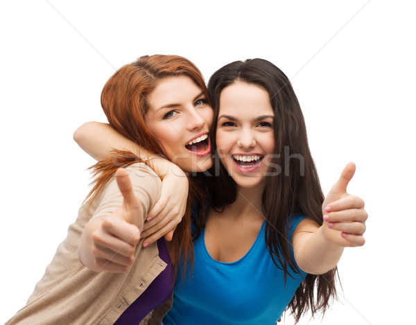 Stock photo: two smiling girls showing thumbs up