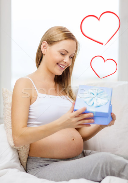 smiling pregnant woman opening gift box Stock photo © dolgachov