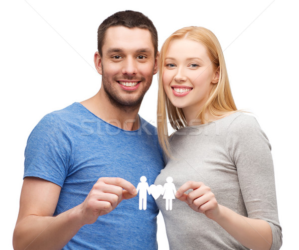 smiling coule holding paper family with heart Stock photo © dolgachov