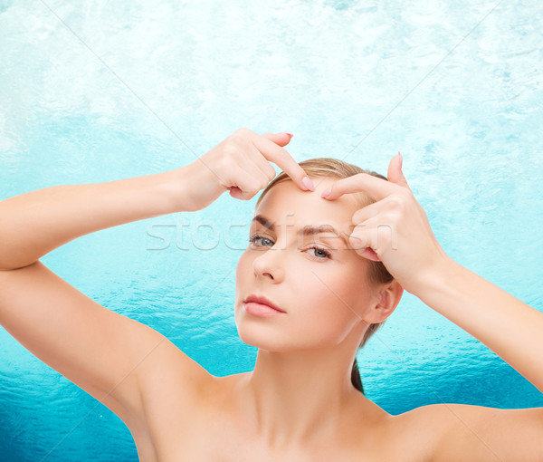 young woman squeezing acne spots Stock photo © dolgachov